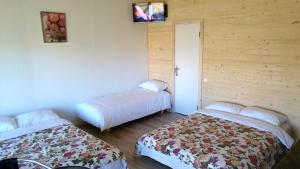 a room with two beds and a tv on the wall at Apartamentai Relax Park in Šventoji +94 photos