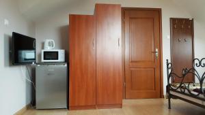 una camera con frigorifero e armadio con forno a microonde di Willa Dzika Róża a Sandomierz
