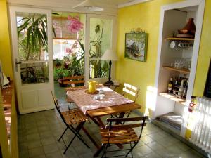 a dining room with a wooden table and chairs at Charming holiday home with private pool in Cavaillon