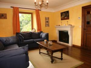 a living room with a couch and a coffee table at Quaint Cottage in Egb mont with Garden in Exbomont