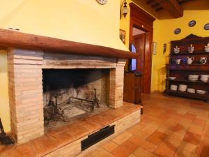 a living room with a brick fireplace at Belvilla by OYO Casa Lella in Serrungarina
