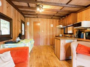 a kitchen with wooden walls and wooden flooring at Sympathic Chalet not far from La Roche en Ardennes in La Roche-en-Ardenne