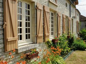a row of windows with shutters on a house at Country cottage with enclosed garden in Bligny in Bligny