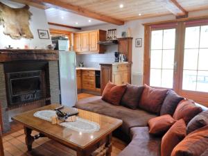 a living room with a couch and a fireplace at Charming Chalet in Ventron with Terrace in Ventron