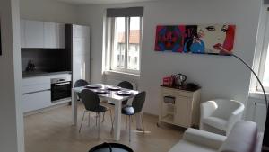 a living room with a table and chairs and a kitchen at Greg's Great Location Apartment in Ljubljana