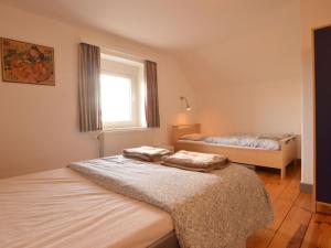 Uma cama ou camas num quarto em Holiday Home in Heppenbach with Garden