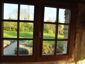 a window with a view of a field outside at Detached holiday home in the Normandy countryside in Saint-Germain-du-Pert
