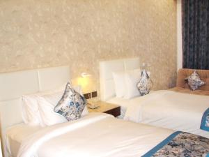 Postel nebo postele na pokoji v ubytování Hotel Grand Maple