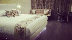Postel nebo postele na pokoji v ubytování Hotel Grand Maple