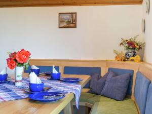 a dining room table with blue dishes on it at Apartment in Reitersau near the ski area in Steingaden