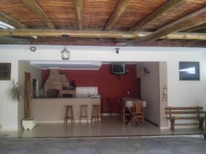 a living room with a table and chairs in a building at Pousada Nossa Casa in Aparecida