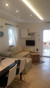 a living room with a couch and a table at Apartment Luna in Cres