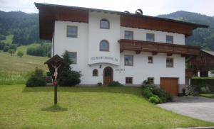a large building with a sign in front of it at Sixenhof in Niederau +11 photos