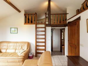 a living room with a couch and a loft bed at Attached gite on the edge of the forest in Trois-Ponts