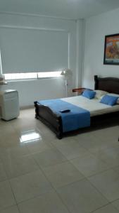 מיטה או מיטות בחדר ב-Arco Apartasuites