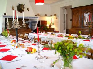 a large dining room with white tables with red napkins at Heritage Castle in Asni res with Garden in Asnières