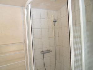 a shower with a glass door in a bathroom at Welcoming Cottage in Hatrival with Terrace in Saint-Hubert