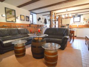 a living room with couches and tables in a room at Holiday Home in Ittel with Balcony Heating BBQ Parking in Welschbillig