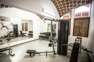 a gym with several tread machines and a mirror at Hotel Las Dunas in Ica