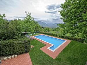 a swimming pool in the yard of a house at Belvilla by OYO Villa Insieme in San Valentino in Abruzzo Citeriore