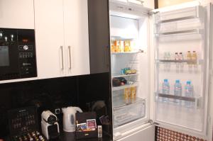 a refrigerator with its door open with drinks in it at Luxury Apartment Plus Ultra in Seville