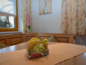 a basket of fruit sitting on top of a table at Holiday flat with swimming pool in Prackenbach in Viechtach