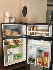 a refrigerator with its door open and food inside at Historic Windsor in Silver Plume