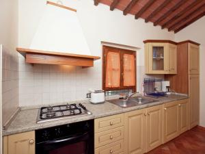 a kitchen with a sink and a stove at Belvilla by OYO San Martino in Ambra