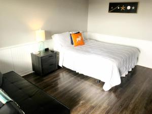 a bedroom with a bed and a night stand with a lamp at The Iona Heights Inn in Iona