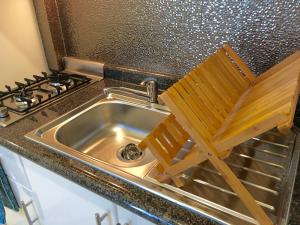 a wooden chair sitting in a kitchen sink at Herbal Inn Suites in Puebla +61 photos