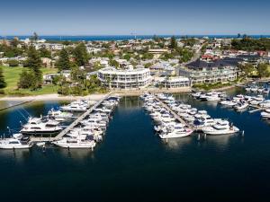 an aerial view of a marina with boats in the water at Pier 21 Apartment Hotel Fremantle in Fremantle