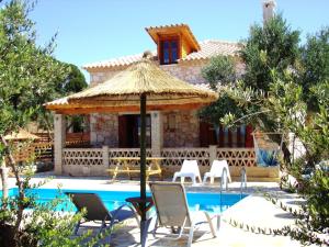 a villa with a swimming pool and a resort at Alegria Villas Complex in Vasilikos