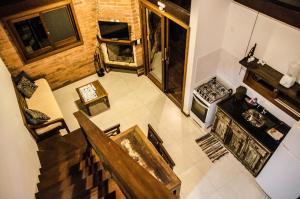 an overhead view of a living room with a table and a stove at Amanita Rosa in Praia do Rosa