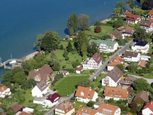 an aerial view of a village with houses and the water at Gästehaus Hornstein in Nonnenhorn
