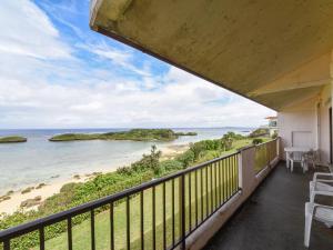 a balcony with a view of the beach at Pension Hoshinosuna in Iriomote