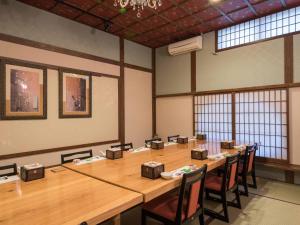 都城的住宿－常盤莊日式旅館，大房间设有一张长木桌子和椅子