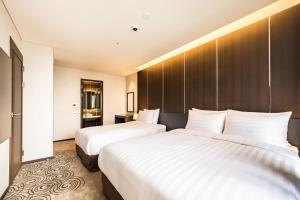Postel nebo postele na pokoji v ubytování Golden Daisy Hotel