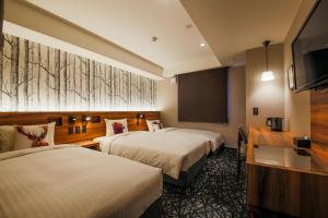 Tempat tidur dalam kamar di Hotel Code Shinsaibashi