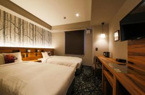 Кровать или кровати в номере Hotel Code Shinsaibashi