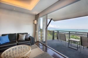 a living room with a couch and a table at Mantra Samui Resort - Adults Only in Mae Nam