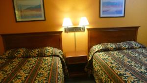 A bed or beds in a room at Allstate Inn