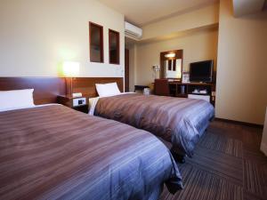 Postel nebo postele na pokoji v ubytování Hotel Route-Inn Gotenba Eki-Minami + 32 fotografií