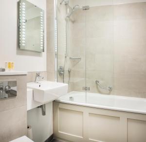 a bathroom with a sink and a tub and a shower at De Vere Beaumont Estate in Windsor