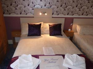 um quarto de hotel com uma cama com toalhas em The Avon em Blackpool