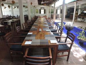 a restaurant with tables and chairs in it at Pigeon Island Beach Resort in Nilaveli
