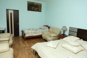 a living room with two beds and a couch at Inter Boutique Hotel in Yerevan