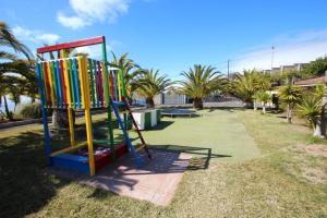 un parque infantil con un tobogán colorido en un parque en Apartment Colibri Finca Montimar, en Los Carrizales