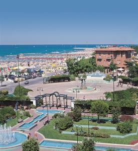 a view of a park with a beach in the background at Hotel Villa Fulgida in Cattolica