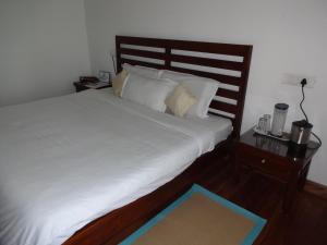 Postel nebo postele na pokoji v ubytování Irinjalakuda House