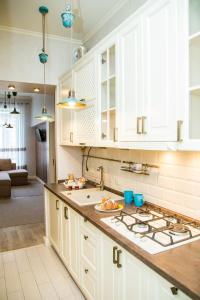 a kitchen with white cabinets and a counter top at Apartments in Scandinavian Style in Lviv